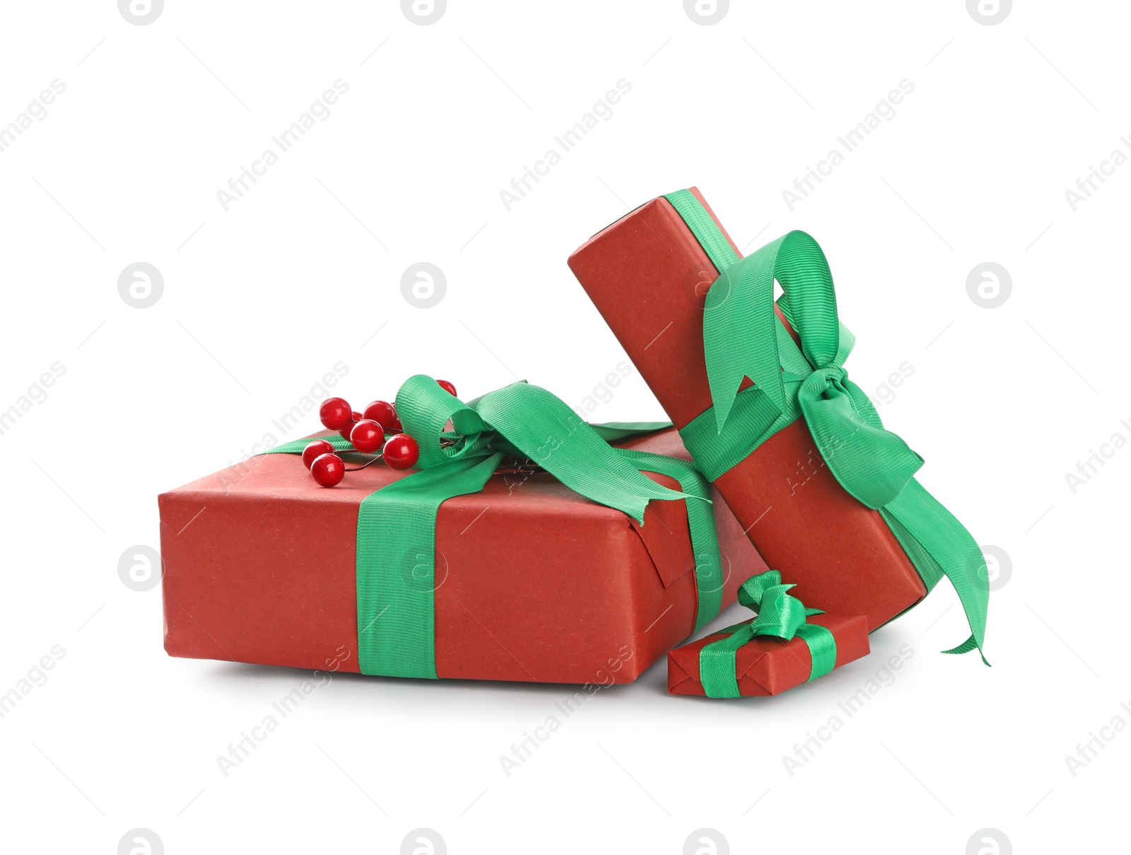 Photo of Christmas gift boxes with green bows and berries on white background