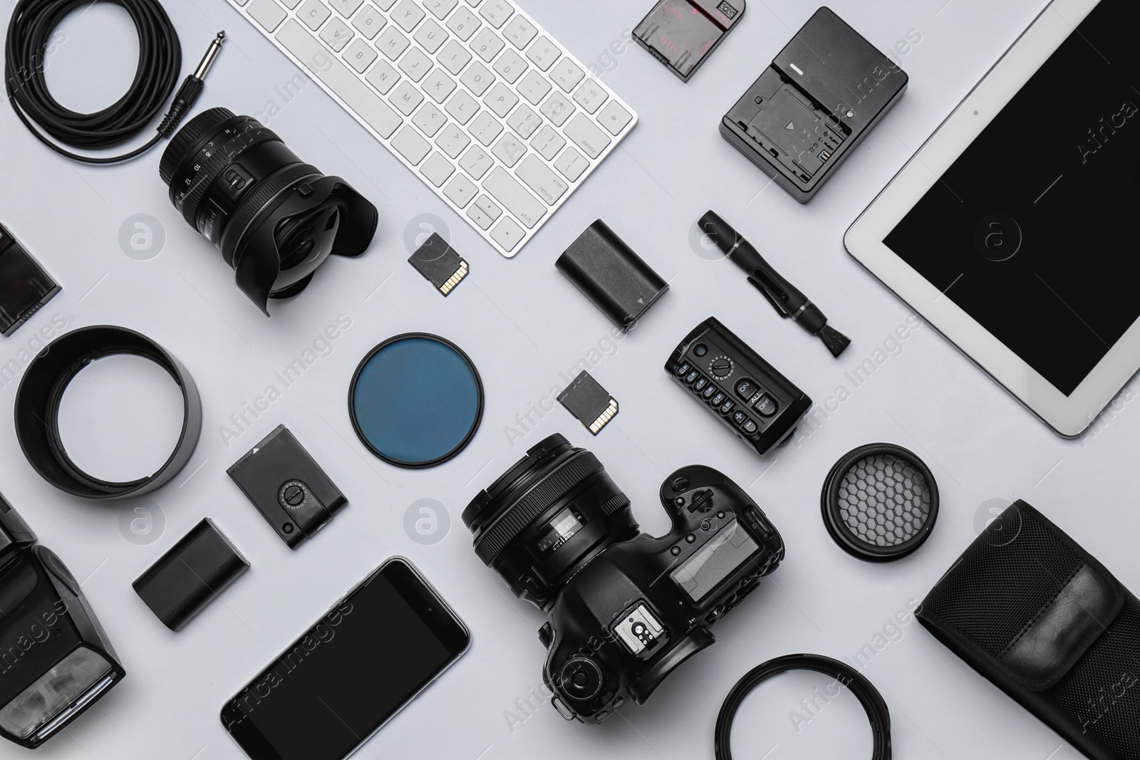 Photo of Flat lay composition with equipment for professional photographer on white background