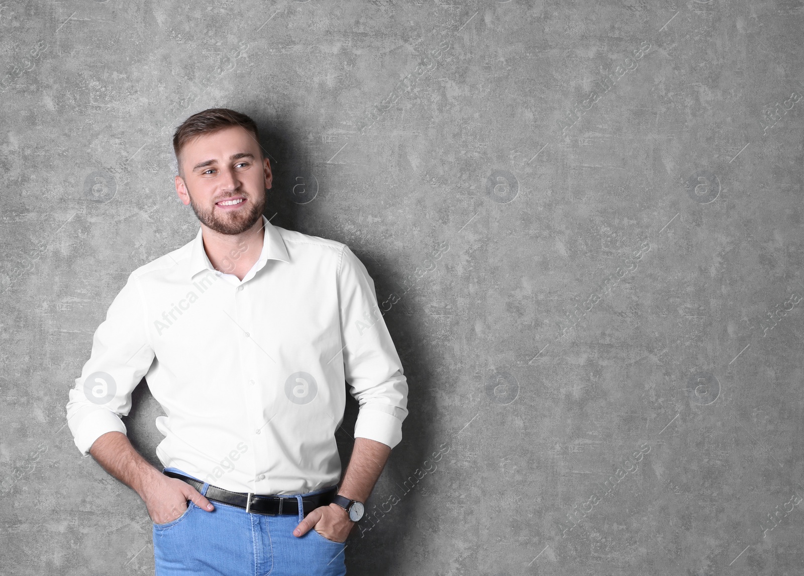 Photo of Portrait of handsome happy man on grey background, space for text