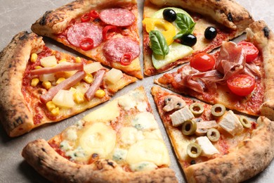 Photo of Slicesdifferent delicious pizzas on table, closeup