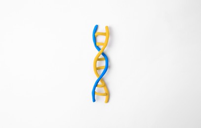 Photo of DNA molecule model made of colorful plasticine on white background, top view