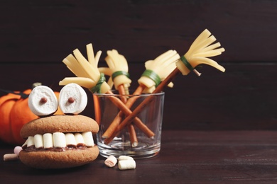 Photo of Delicious Halloween themed desserts on wooden table