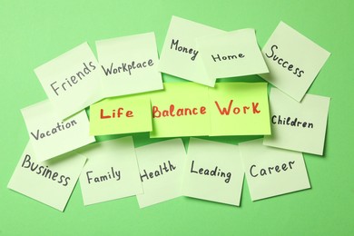 Photo of Sticky notes with words on green background. Life and work balance concept