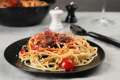 Photo of Delicious pasta with meatballs and tomato sauce served on table