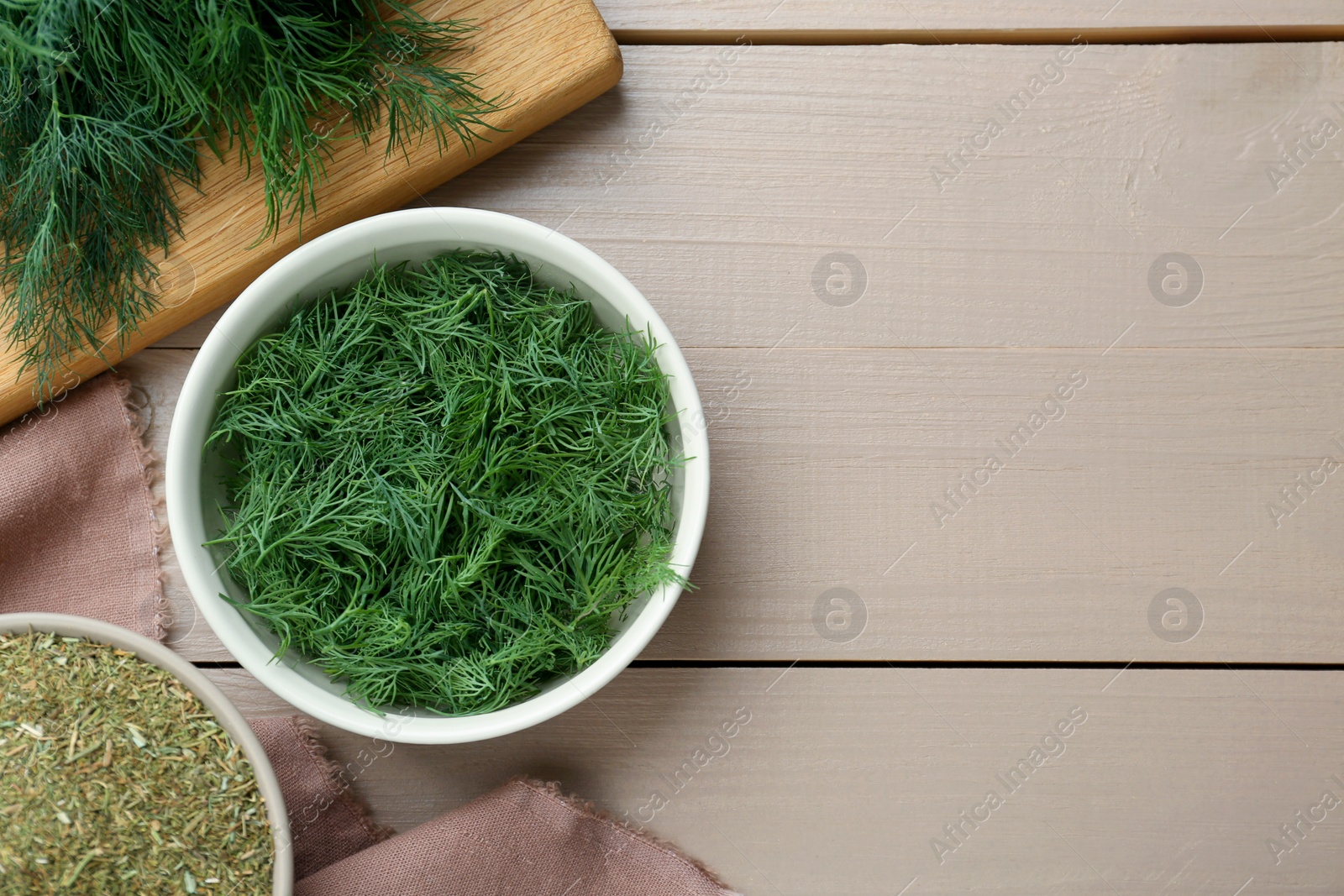 Photo of Dried and fresh dill on wooden table, flat lay. Space for text