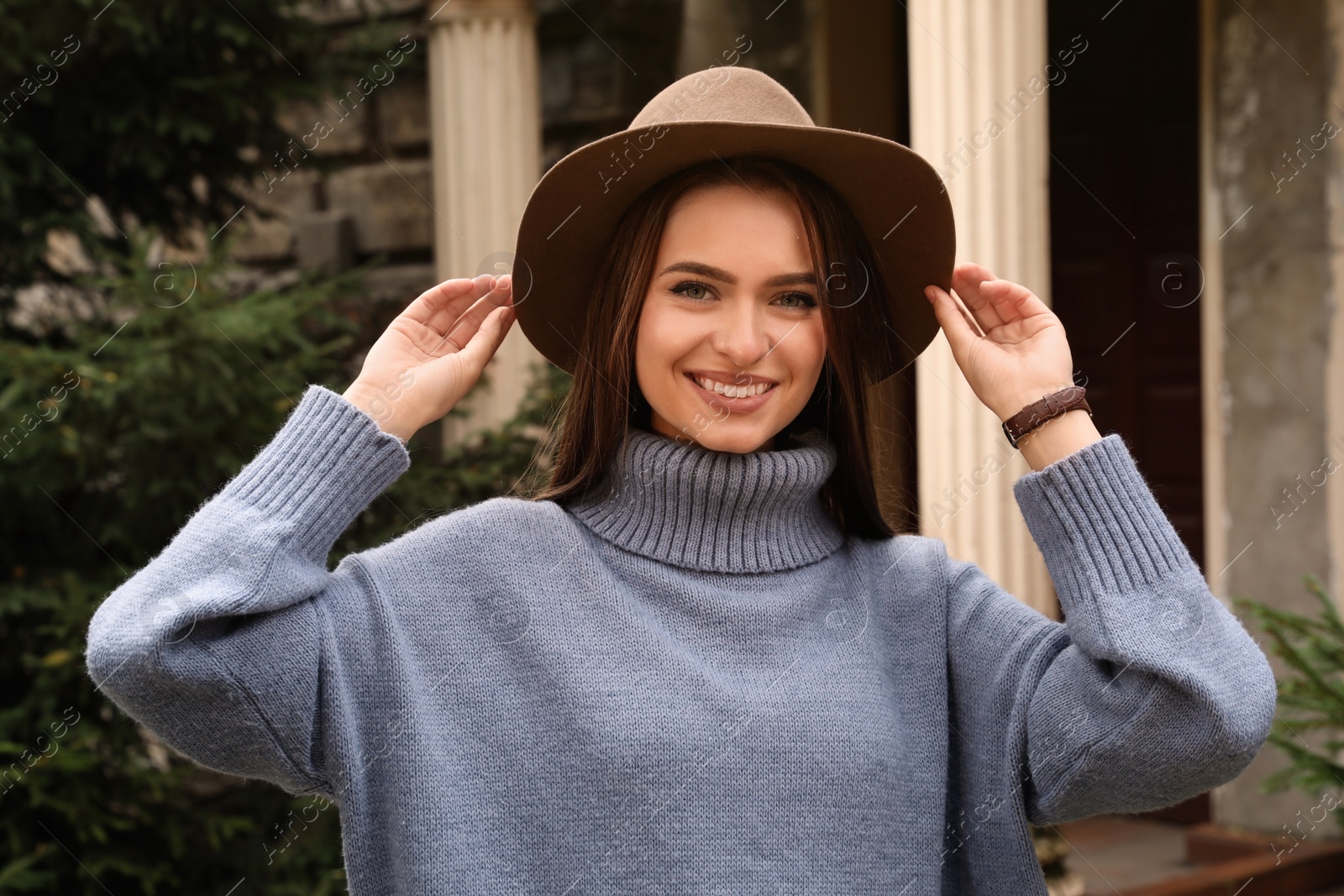 Photo of Beautiful young woman wearing stylish autumn clothes on city street
