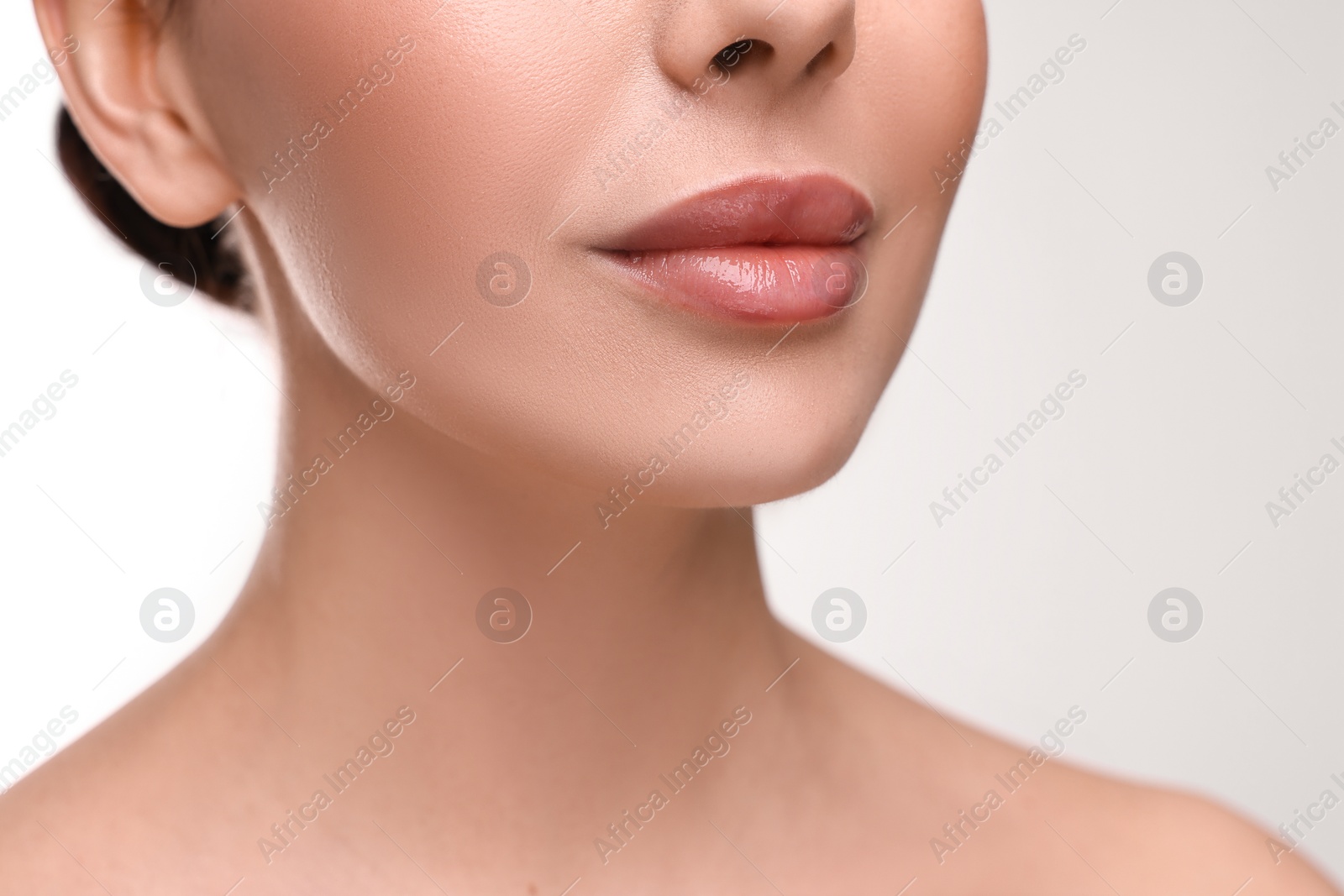 Photo of Woman with beautiful lips on white background, closeup