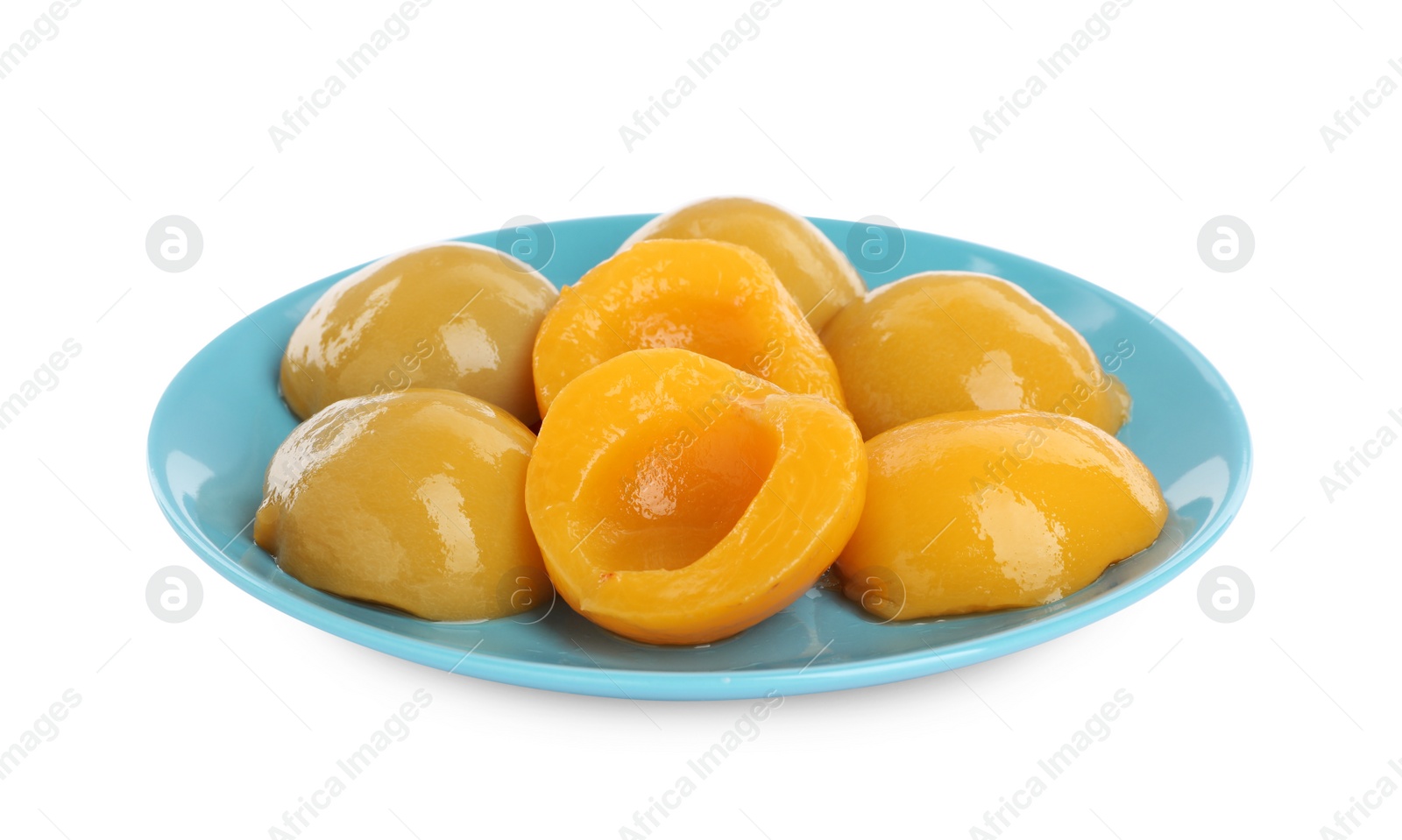 Photo of Plate with canned peach halves isolated on white