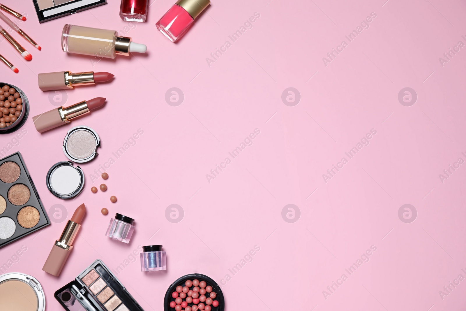 Photo of Flat lay composition with decorative cosmetics on  pink background, space for text