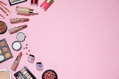 Flat lay composition with decorative cosmetics on  pink background, space for text