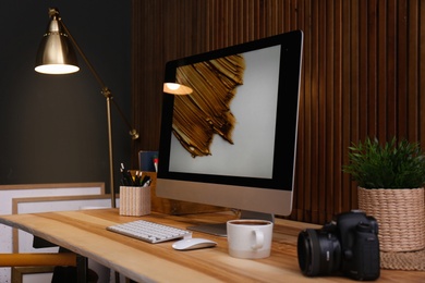 Photo of Modern computer on desk in room. Home workplace