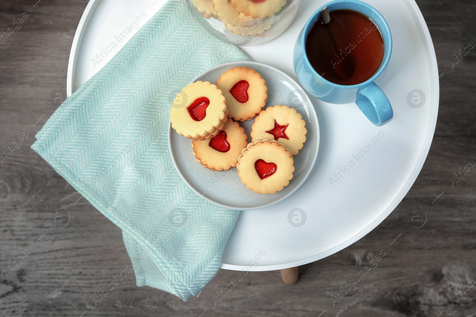 Photo of Traditional Christmas Linzer cookies with sweet jam on table, top view