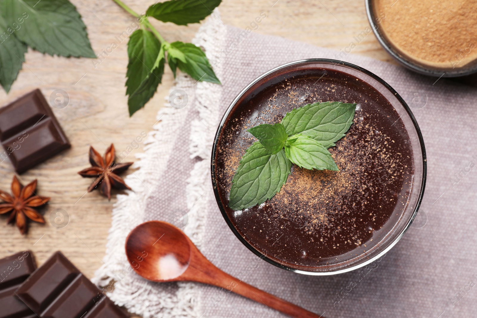 Photo of Flat lay composition with glass of delicious hot chocolate and fresh mint on wooden table