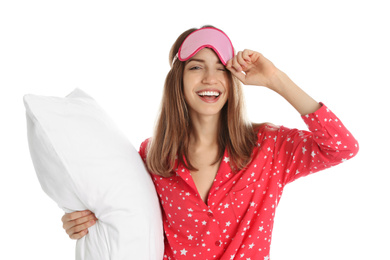 Beautiful woman with pillow and sleep mask on white background. Bedtime