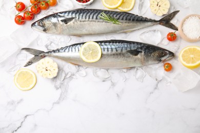 Photo of Tasty raw mackerel and ingredients on white marble table, space for text