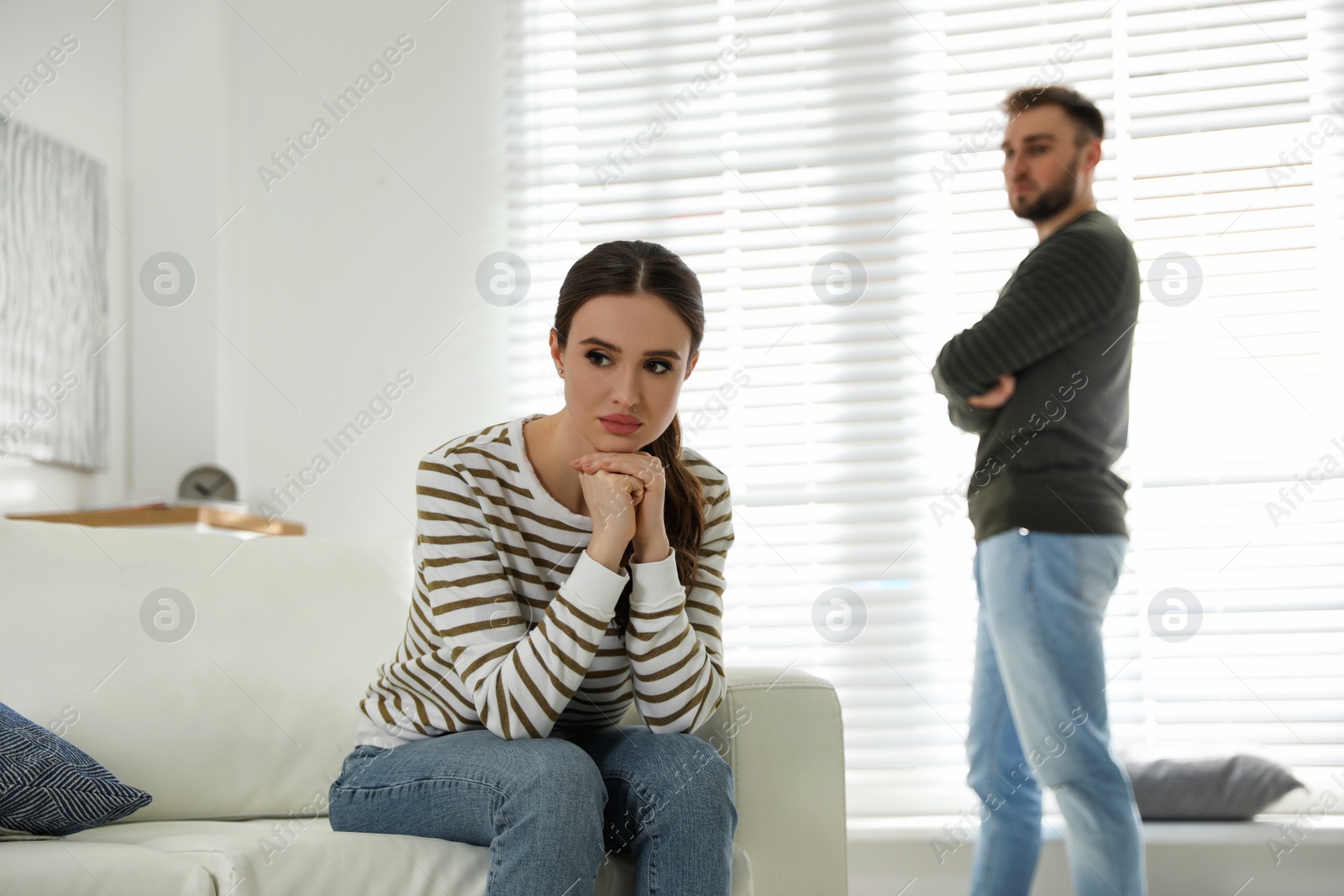 Photo of Young couple quarreling at home. Jealousy in relationship