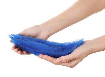 Woman holding blue felting wool on white background, closeup