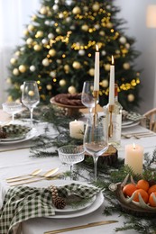 Christmas table setting with festive decor and dishware indoors