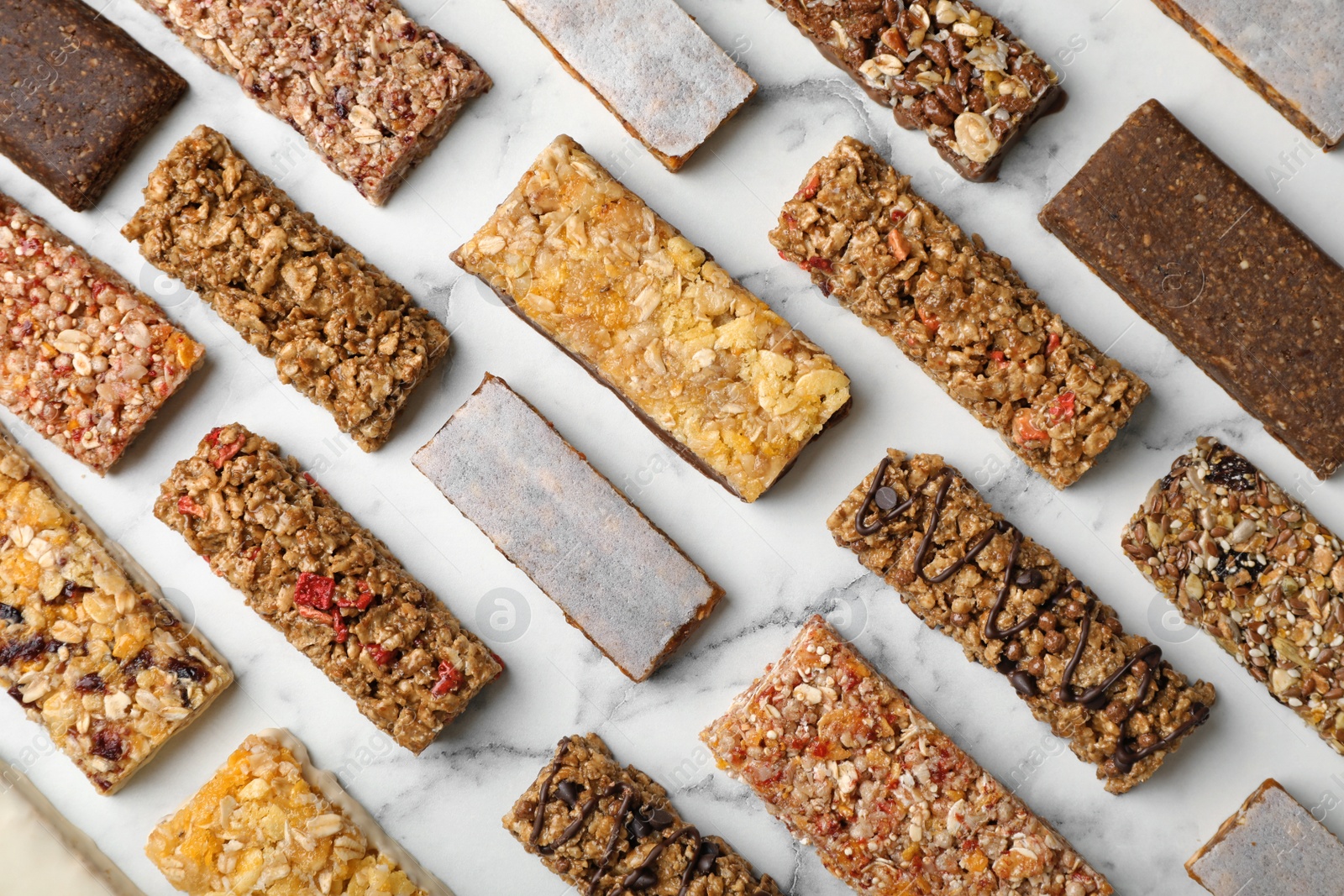 Photo of Flat lay composition with protein bars on marble background