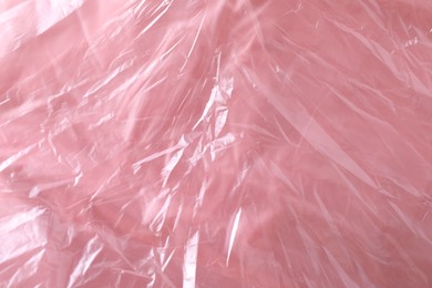 Texture of coral plastic bag as background, closeup