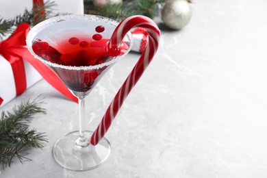 Photo of Delicious Christmas cocktail with liqueur on grey table, space for text