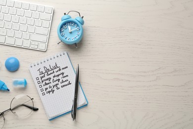 Flat lay composition with to do list on wooden table, space for text