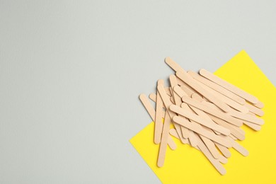 Pile of spatulas on color background, flat lay. Space for text