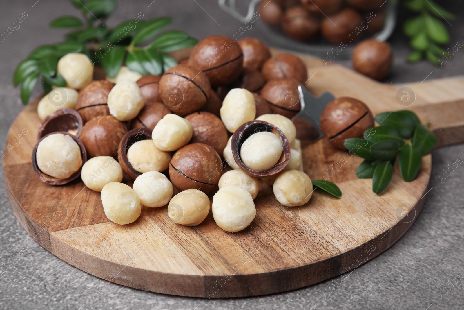 Photo of Tasty organic Macadamia nuts on grey table