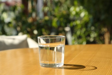 Glass of fresh water on wooden table