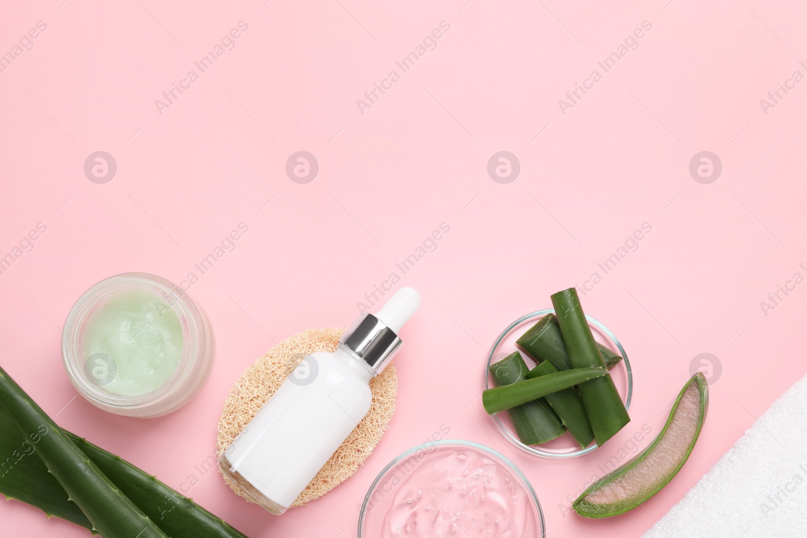 Photo of Flat lay composition with cosmetic products and cut aloe leaves on pink background. Space for text