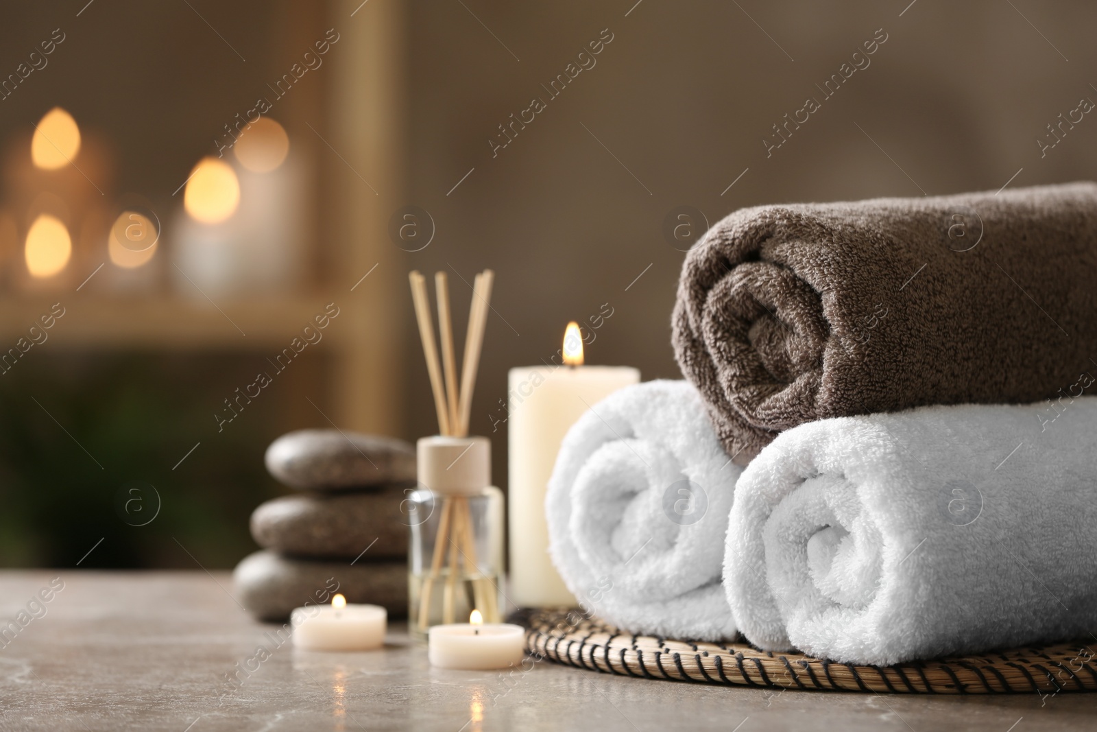 Photo of Beautiful composition with spa stones on grey marble table, closeup