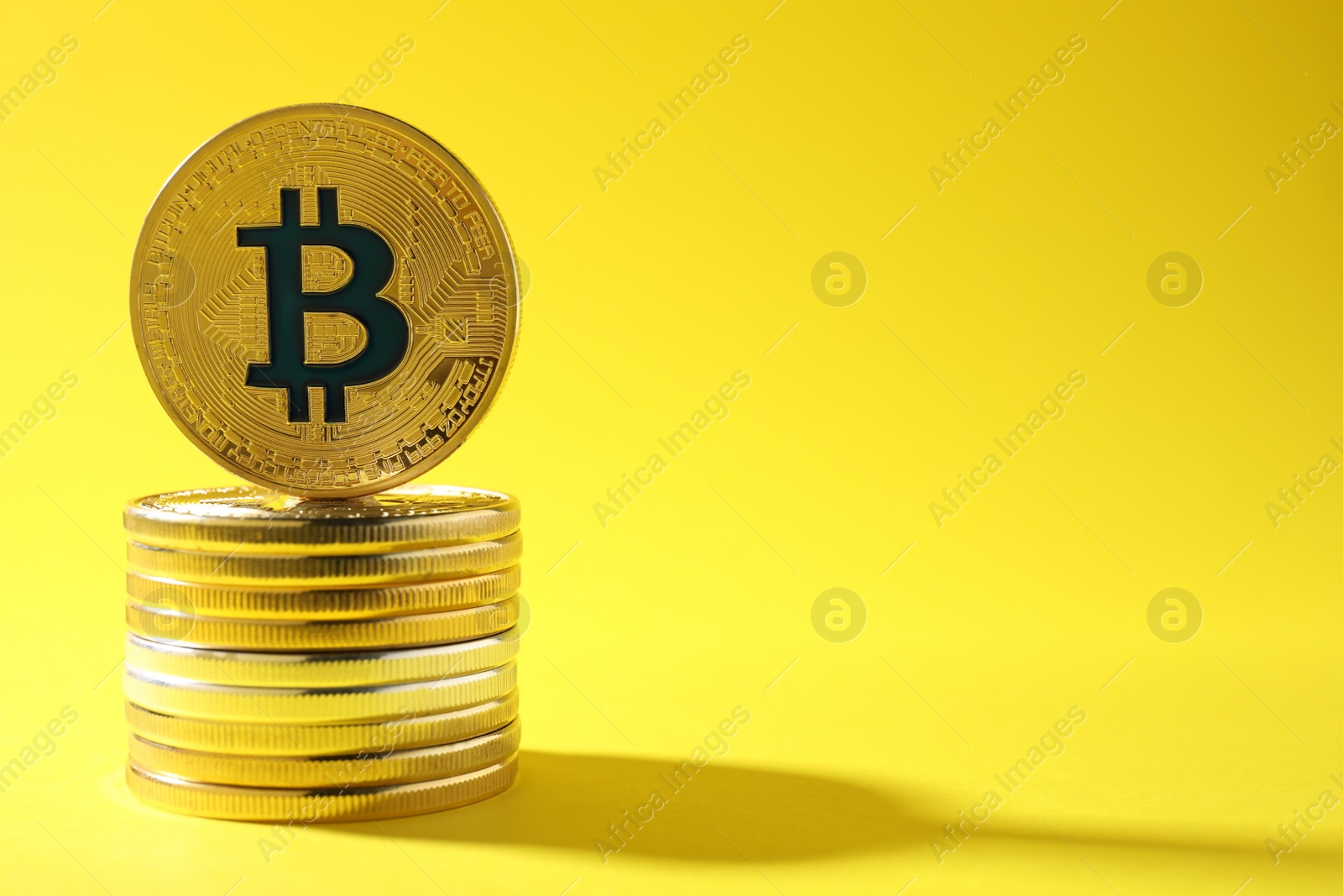 Photo of Stack of bitcoins on color background, space for text. Digital currency