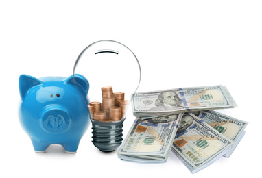 Image of Light bulb with stacked coins inside, piggy bank and banknotes on white background. Energy efficiency, loan, property or business idea concepts