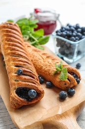 Fresh delicious puff pastry with sweet berries served on white wooden table