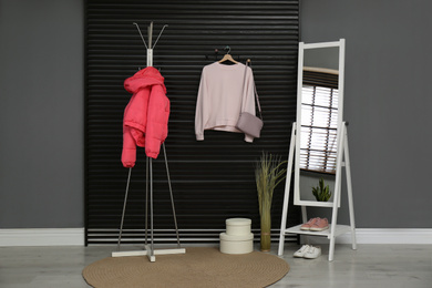 Photo of Hallway interior with stylish furniture, clothes and accessories