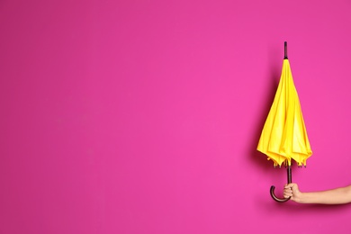 Photo of Woman holding beautiful umbrella on color background with space for design