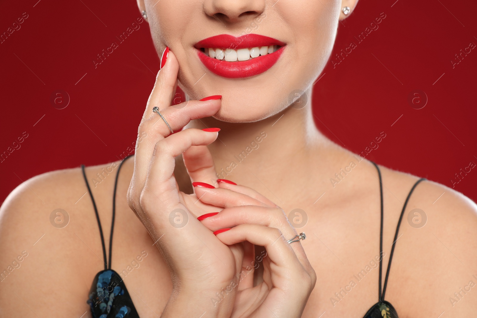 Photo of Beautiful young woman with bright manicure on color background, closeup. Nail polish trends