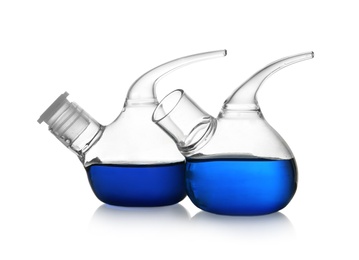 Retort flasks with blue liquid on white background. Laboratory glassware