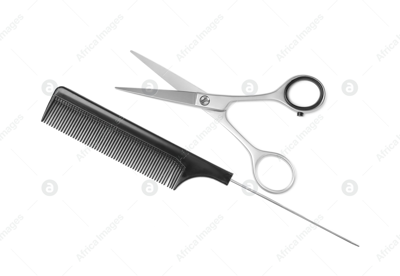 Photo of New scissors and comb on white background, top view. Professional tool for haircut