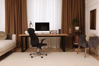 Photo of Stylish room interior with comfortable workplace near window