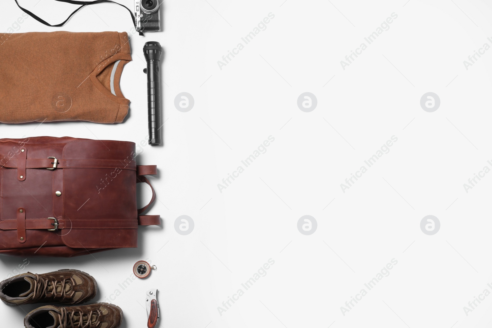 Photo of Composition with leather tourist backpack and camping equipment on white background, flat lay. Space for text