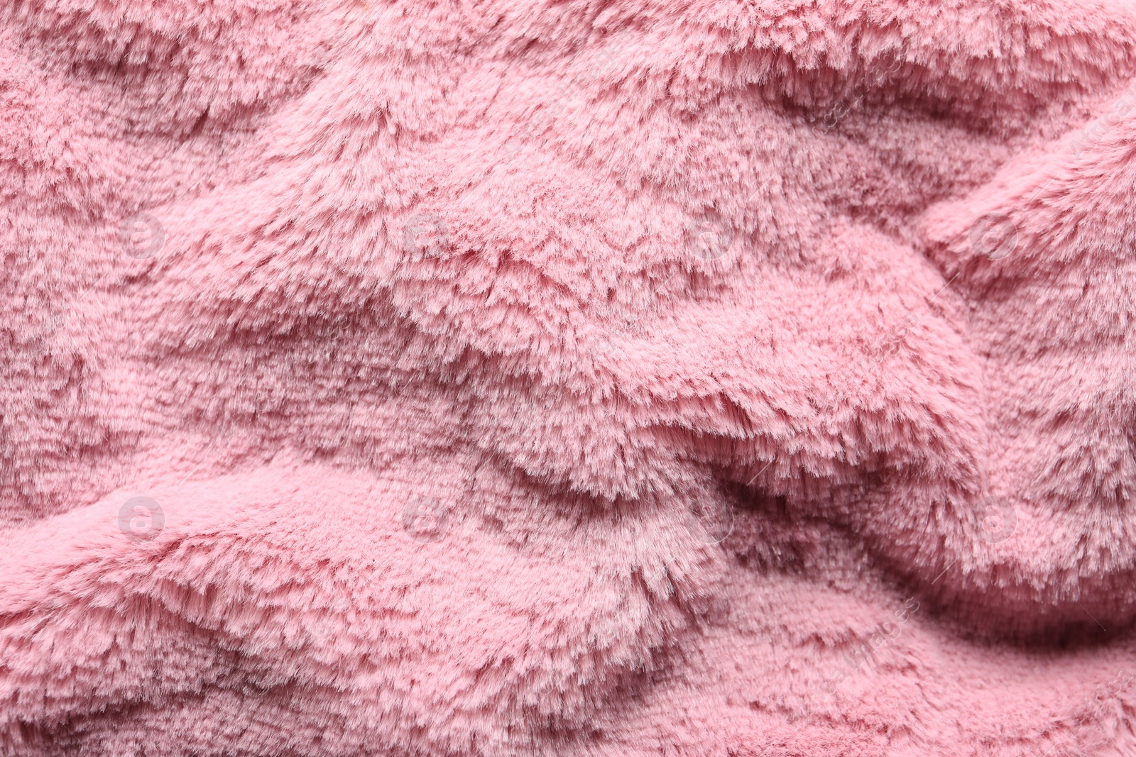 Photo of Texture of pink faux fur as background, top view