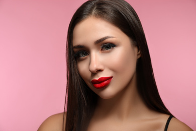 Photo of Beautiful woman with red lipstick on pink background