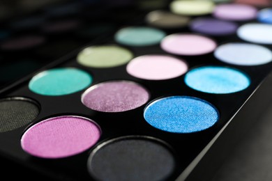 Photo of Colorful eyeshadow palette on grey background, closeup