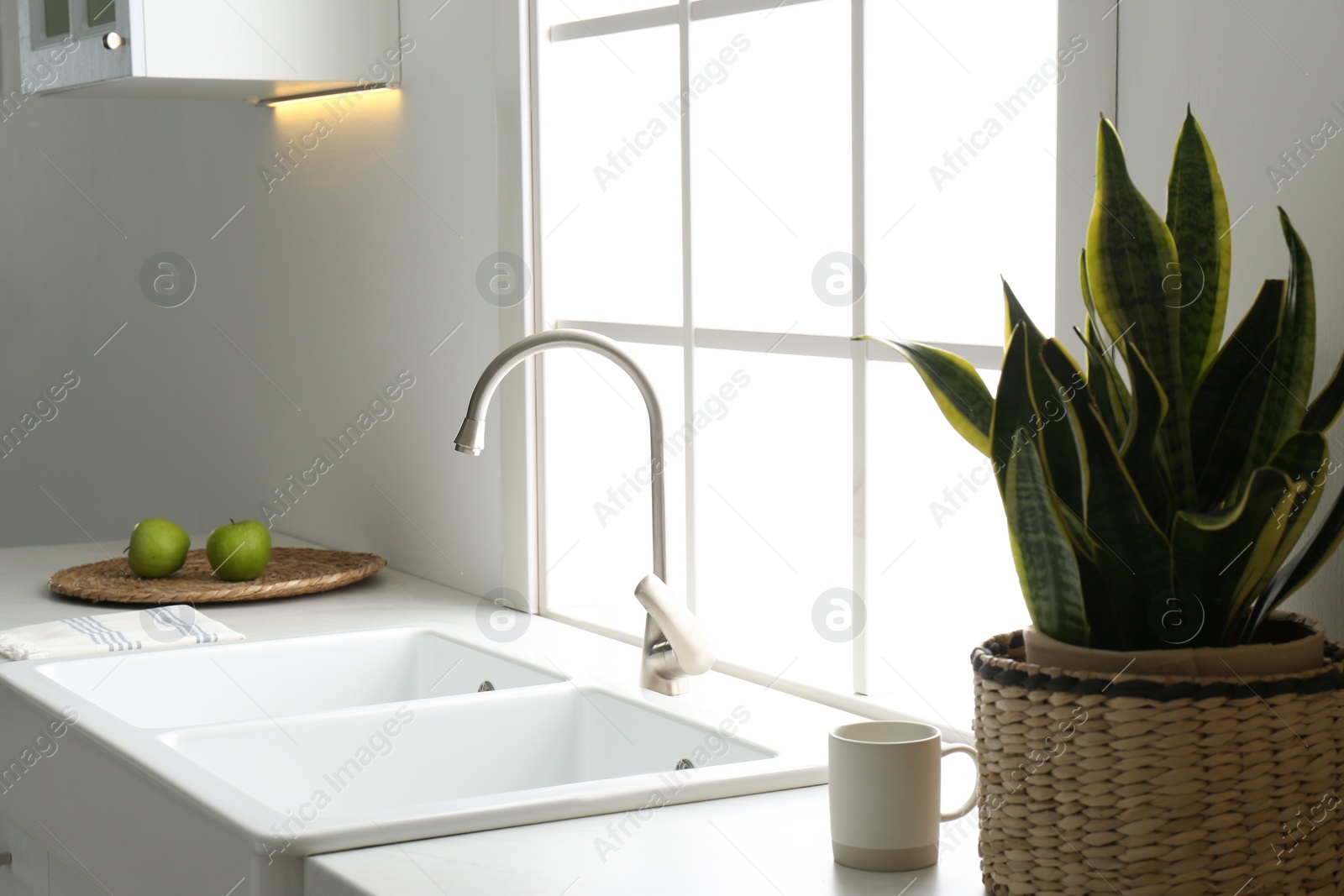 Photo of New ceramic sink and modern tap in stylish kitchen interior