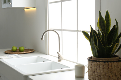 New ceramic sink and modern tap in stylish kitchen interior