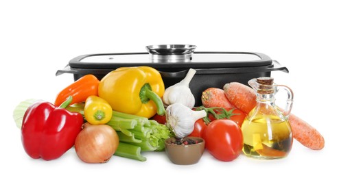 Photo of Black pot with glass lid and pile of fresh products isolated on white