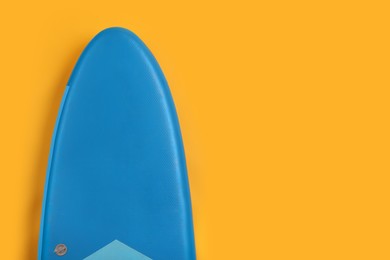 Photo of One SUP board on yellow background, top view with space for text. Water sport