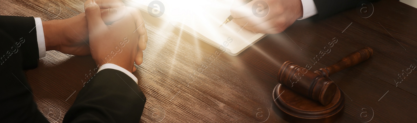 Image of Law and justice. People working with documents at wooden table, closeup. Banner design