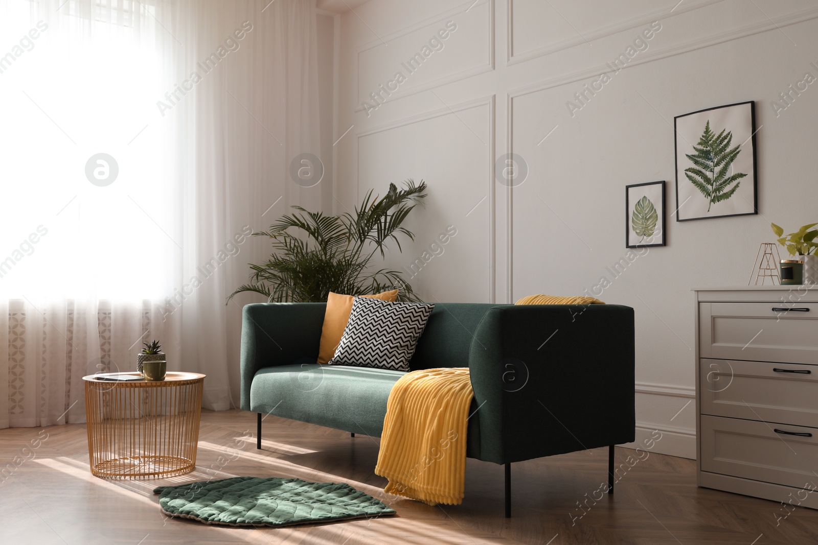 Photo of Stylish living room interior with comfortable green sofa